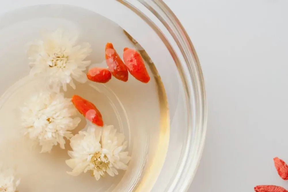 a bowl full of flowers and goji berries