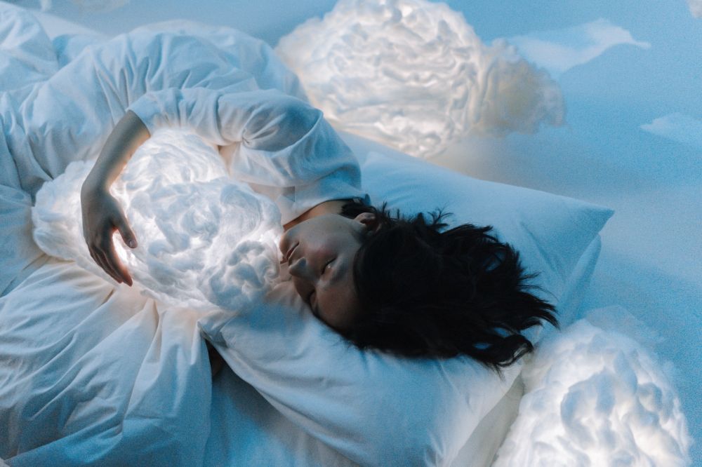 Woman Sleeping in Bed with a Cloud 