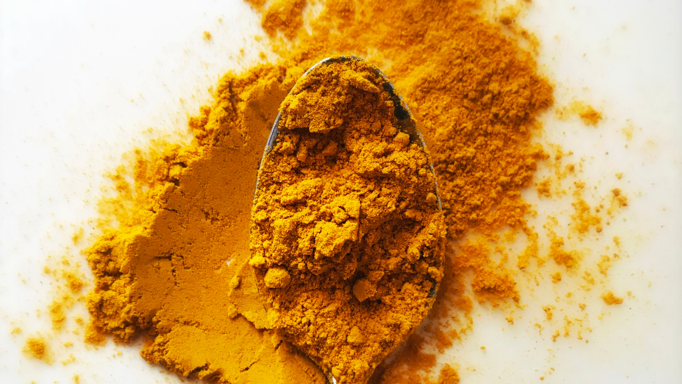 close up of turmeric powder on a spoon