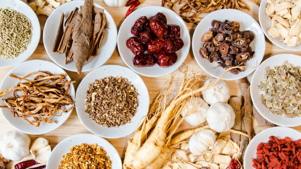 TCM Herbs in bowls on wooden table