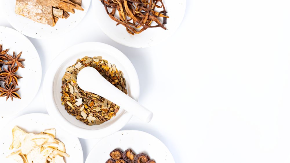 Chinese Herbs in bowls on a white background