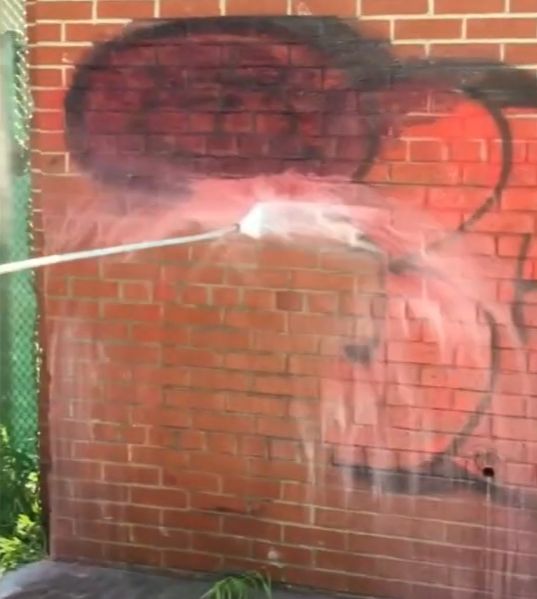 Power Wash Graffiti from brick wall 