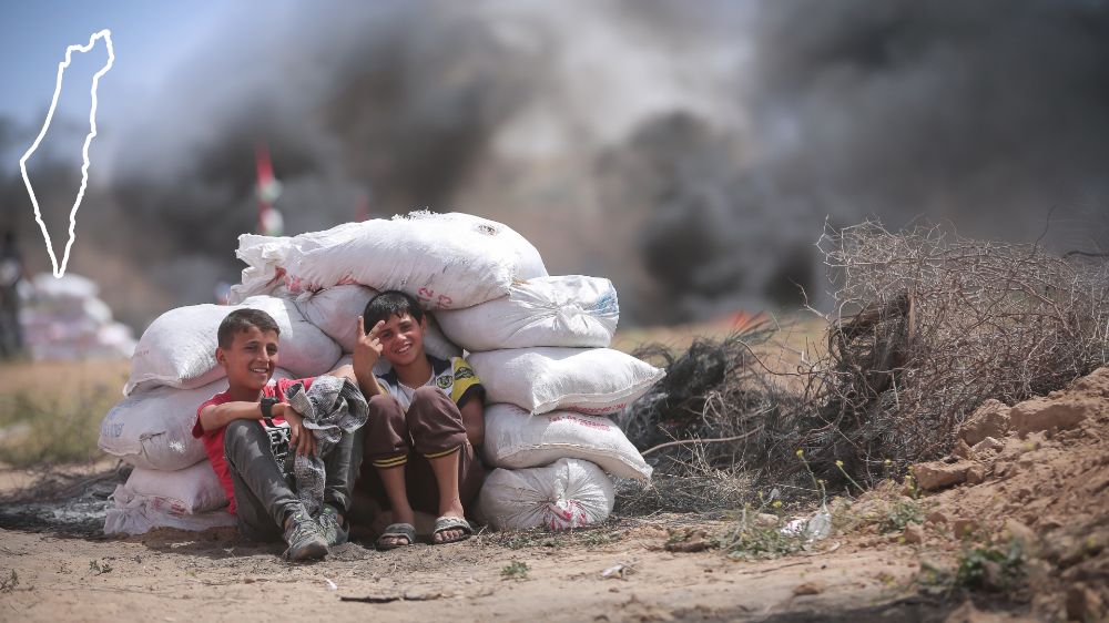 Two Palestinian boys in Gaza hiding during Gaza border protests